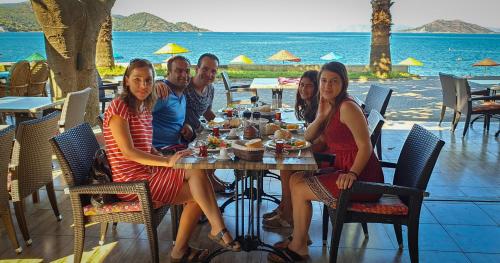 people sitting at a picnic table at Eyna Hotel in Fethiye