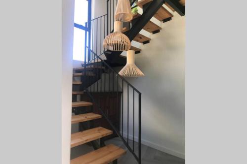 a staircase in a house with rattan hanging baskets at Comfortable Room with Large en suite Bathroom in Franschhoek