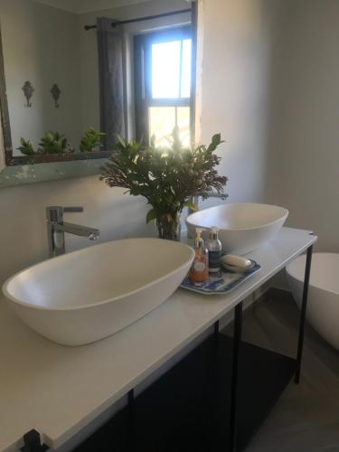 a bathroom with two sinks on a counter at Comfortable Room with Large en suite Bathroom in Franschhoek