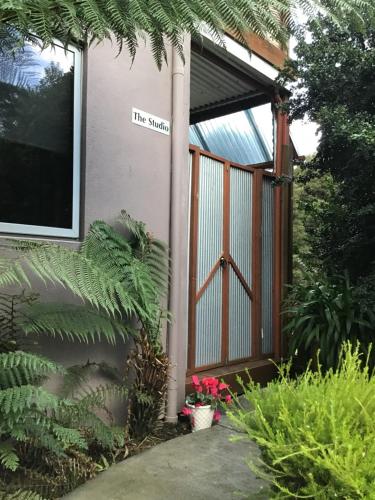 a front door of a house with a sign on it at Ulverstone River Retreat in Ulverstone