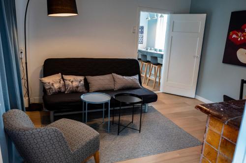 a living room with a couch and a table and chairs at Tranquility Farm in Dalfsen