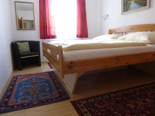 a bedroom with a bed and a window and a rug at Haus Rigl in Schladming