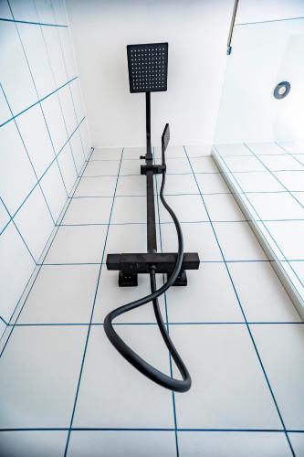 a shower seat sitting on a tiled floor in a bathroom at Monsieur Miot Concept Hotel - Bastia centre in Bastia