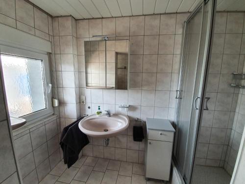 a small bathroom with a sink and a shower at Ferienwohnung Schwarzwaldblick in Unterreichenbach