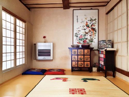 a living room with a large rug on the floor at Ahndong Kimjongtaek Yangsodang in Andong