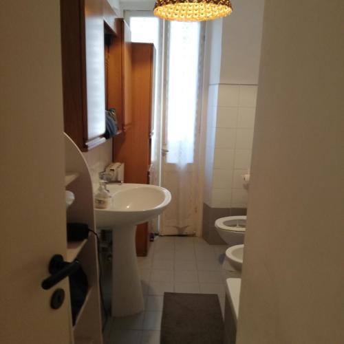 a bathroom with a sink and a toilet and a chandelier at nirvana in Genoa