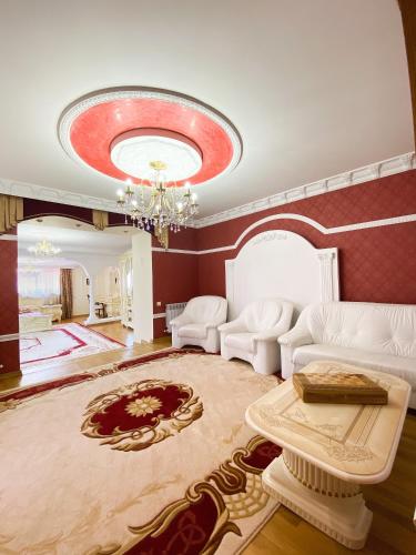 a living room with a couch and a chandelier at Петрос Family Hotel in Yaremche