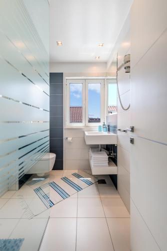 a bathroom with a sink toilet and a window at Apartment Rex Exclusive in Split