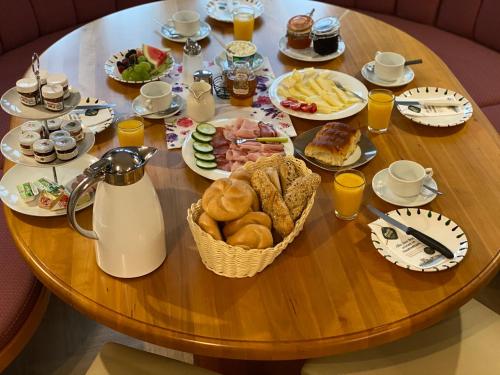 a table with a breakfast of food and drinks at Almtalhotel Appartements in Pettenbach in Pettenbach