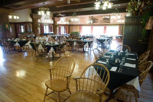 a dining room with tables and chairs in it at Glacier Park Lodge in East Glacier Park