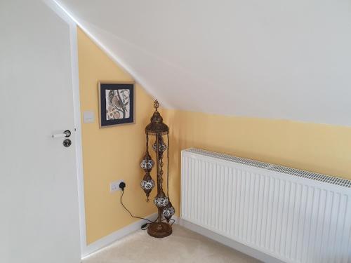 a room with a clock next to a staircase at Lochview in Swannay