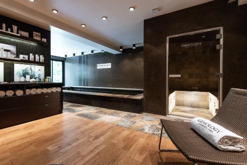 a room with a salon with a chair and a mirror at Hôtel du Château & Spa - Teritoria in Carcassonne
