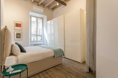 Tempat tidur dalam kamar di Casa Manara in Trastevere
