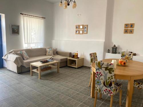 a living room with a couch and a table at Traditional holiday home in Kékhros