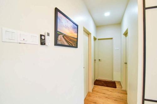 a hallway with a painting hanging on a wall at Sekinchan PaddyView Homestay in Sekinchan