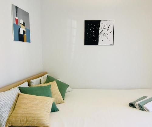 a white room with pillows on a bed at Trogir family space 90m2 in Trogir