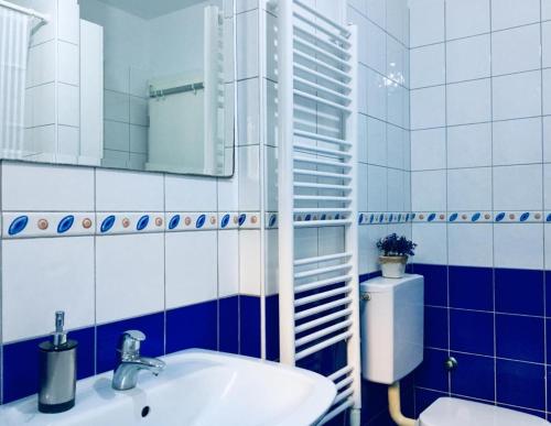 a bathroom with a sink and a mirror and a toilet at Trogir family space 90m2 in Trogir