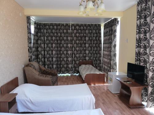 Habitación de hotel con cama y TV en Aparthotel na Abovyana 7, en Novi Afon