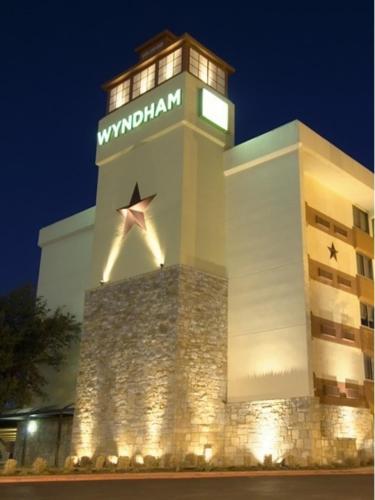 a building with a clock tower at night at Wyndham Garden Hotel Austin in Austin