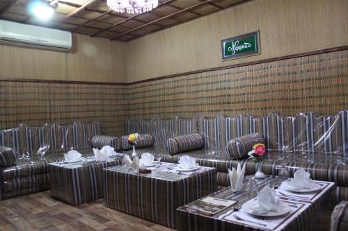 a dining room with tables and chairs in a restaurant at Daraysh Hotel in Sharjah