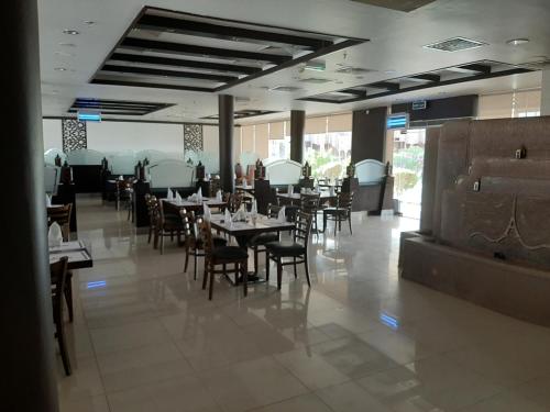 a dining room with tables and chairs in a restaurant at Daraysh Hotel in Sharjah