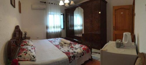 a bedroom with a bed and a table in it at Guest house Naser in Ulcinj