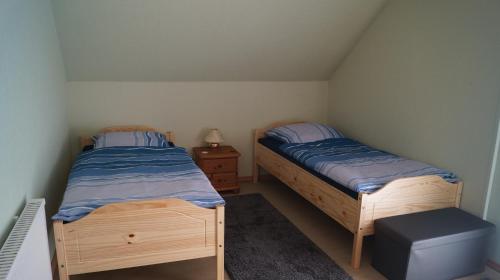 a bedroom with two beds and a night stand at Helmine in Mettlach