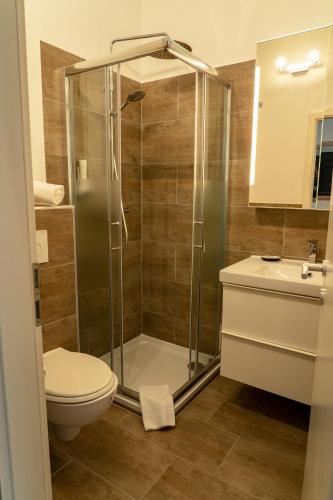 a bathroom with a shower and a toilet and a sink at Gästehaus Moßhammer in Graz