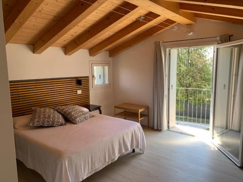 a bedroom with a bed and a sliding glass door at Villavecchia in Castegnero
