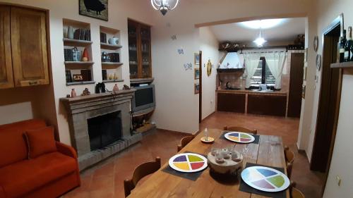 a living room with a table and a fireplace at Villa Greco in Rossano