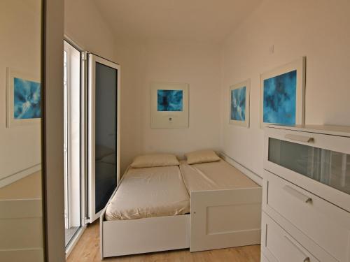 a small bedroom with a bed and a window at Villa Zonzamas in Puerto del Carmen