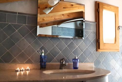 a bathroom counter with a sink and a mirror at Sweet Dream House in Carloforte