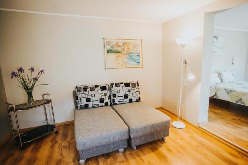 a living room with a couch and a bed at Guest House Baltās Dūjas in Saulkrasti