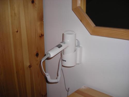 a white hair dryer hanging on a wall at Iglika 2 - Studio Cabin in Borovets