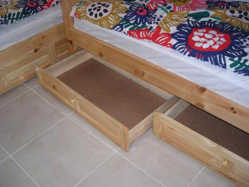 a wooden bunk bed with a box under it at Iglika 2 - Studio Cabin in Borovets