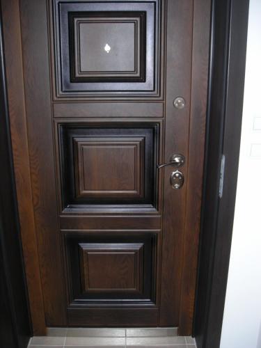 a wooden door in a room with a tile floor at Iglika 2 - Studio Cabin in Borovets