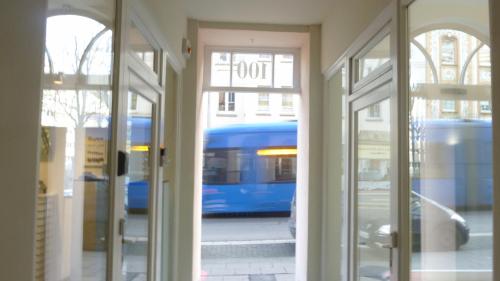 a view of a bus through the doors of a building at Vorderer Westen Kassel in Kassel