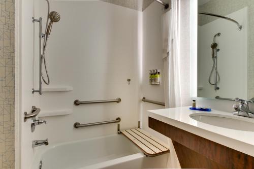 a bathroom with a tub and a sink and a shower at Holiday Inn Express Hotel & Suites Austell Powder Springs, an IHG Hotel in Austell