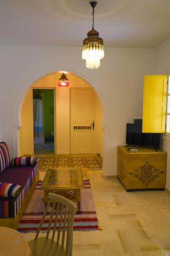 a living room with a couch and a table at Dar El Jerbi in Mezraya