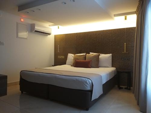 a bedroom with a large bed in a room at Tuck Inn in Larnaka