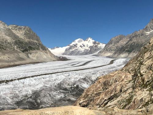 a glacier in the mountains with a snow covered mountain at Chalet Foresta in Bettmeralp