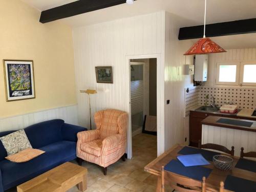 a living room with a blue couch and a table at L'étang des Mirandes in Varaignes