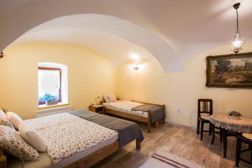 A bed or beds in a room at Bakony-Cinca Vendégház