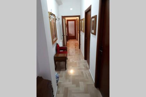 a hallway with a long hallway with a floor of tiles at Comodo appartamento a due passi dalla stazione in Macerata