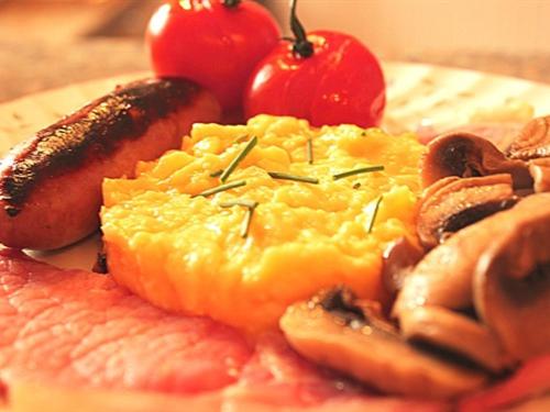 a plate of food with meats and tomatoes on it at Moss Cottage in Stratford-upon-Avon