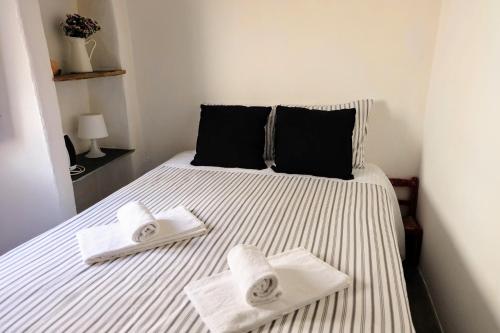 a bedroom with a bed with two towels on it at Casa das Videiras in Monsaraz