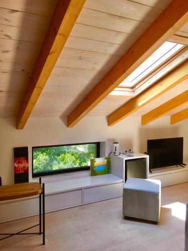 a living room with a large flat screen tv at Rea Boutique Hotel in Himare