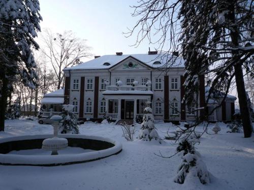 a large white house with snow on the ground at Willa Park in Ostrowiec Świętokrzyski