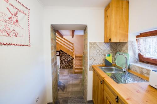 a kitchen with a sink and a wooden counter top at Bakony-Cinca Vendégház in Szentgál