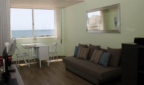 a living room with a couch and a table at Marisol 2F Waterfront in Armação de Pêra